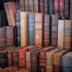 Fiera di libri antichi a Milano, collezionisti esaminano volumi rari in un'atmosfera vivace.