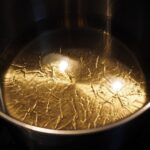 Olio in padella con ingredienti freschi pronti per essere aggiunti.